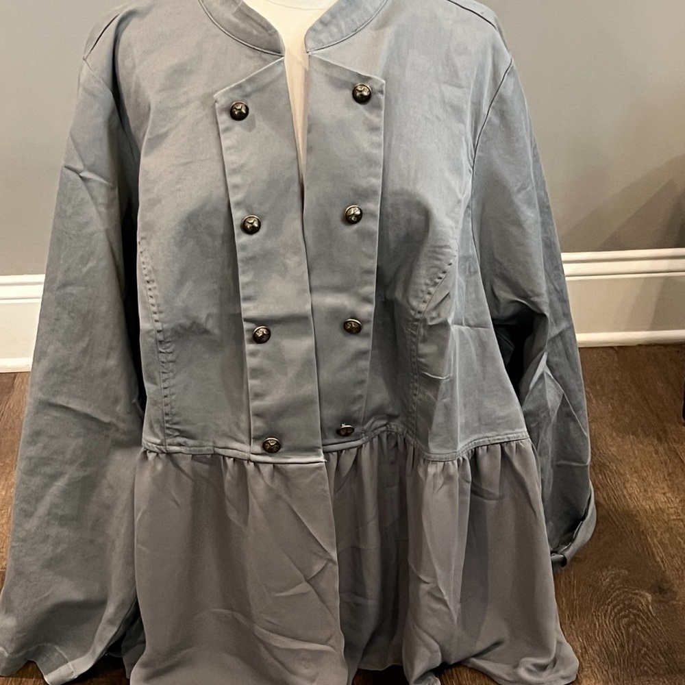 Military style jacket and a slate blue color where where is brass buckles